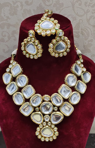 Lustrous Golden Color Kundan Necklace with Matha Tikka and Jhumka with Back Meenakari