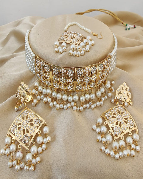 Beautiful Golden Color Necklace, Earrings and Matha Tikka with Charming White Color added Pearls for Special Occasion