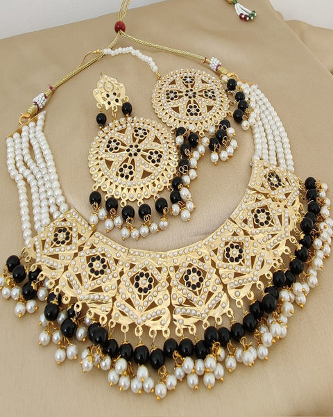 Charming Golden Color Jadau Choker Necklace with Earrings and Matha Tikka with Beautiful Black Color Pearls for Special Occasion