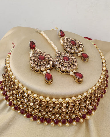 Charming Golden Color Necklace, Earrings and Matha Tikka with Beautiful Maroon Color Pearls for Special Occasion