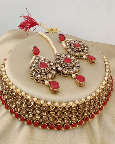 Dazzling Golden Color Necklace, Earrings and Matha Tikka with Charming Red Color Pearls for Special Occasion