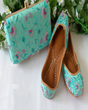 Beautiful Light Blue Color Handcrafted Intricately Designed Jutti and Purse Combo with Charming Pink Color Floral Design