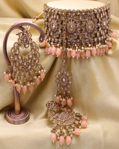 Gorgeous Golden Color Premium Quality Full AD Stone Choker Necklace, Earrings and Matha Tikka with Beautiful Pink Color Pearls on both Necklace and Earrings for Special Occasion